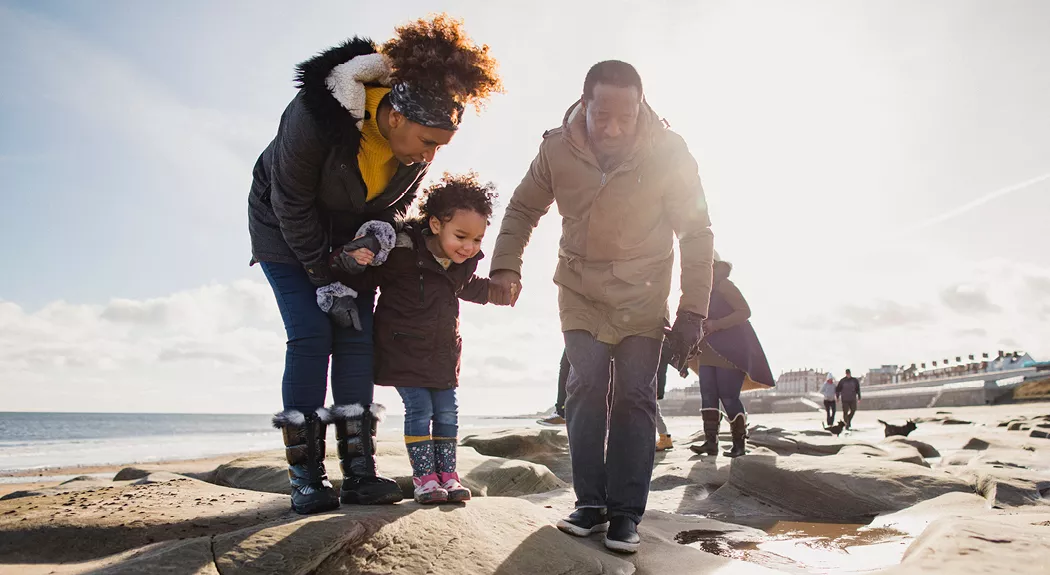 Family walking together on the beach