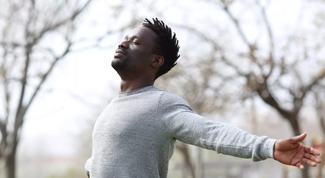 Happy African-American man stretching