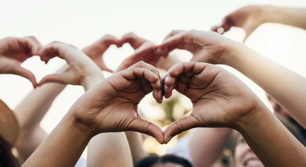 Diverse hands forming a heart shape