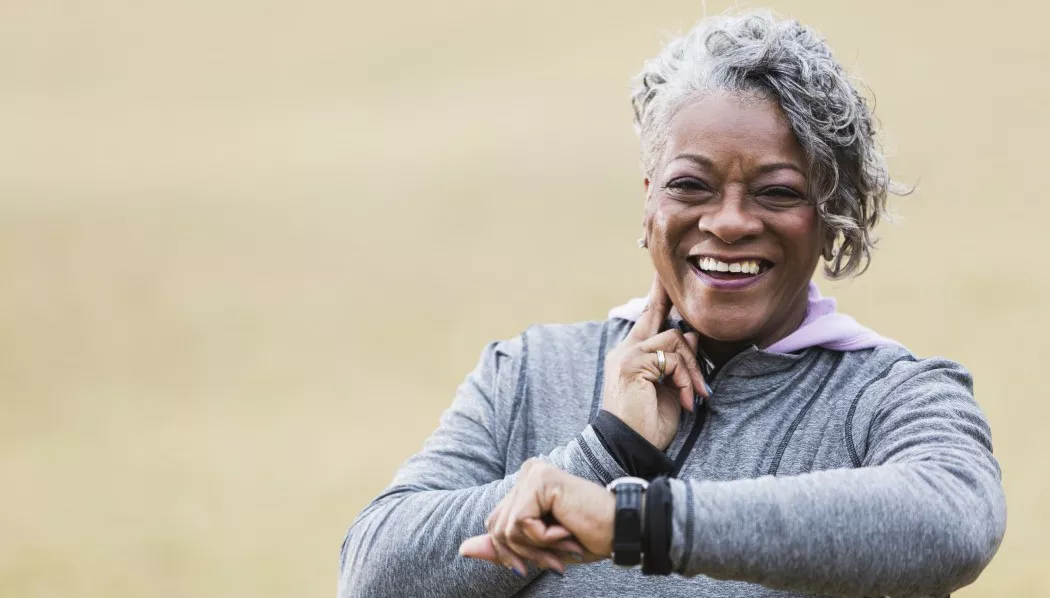 Senior woman exercising, taking pulse