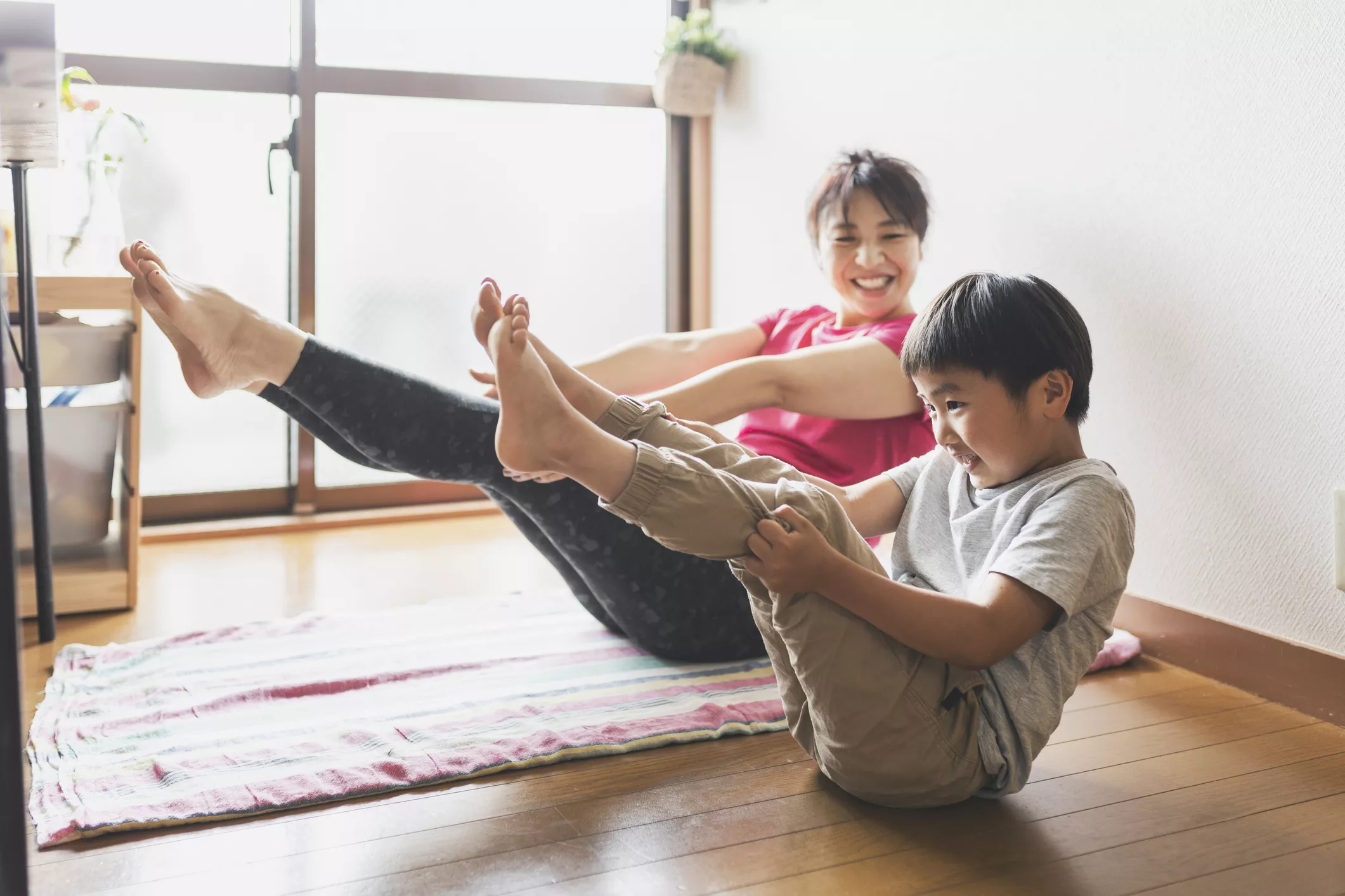 Mother and son exercising Yoga together at home