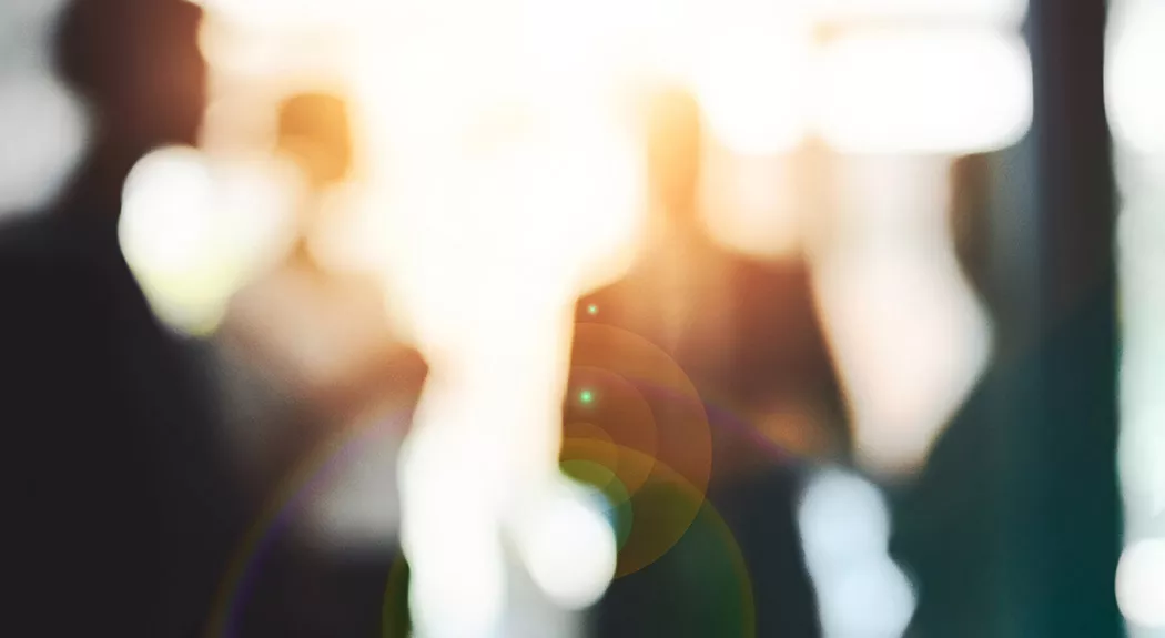 group of people standing in light