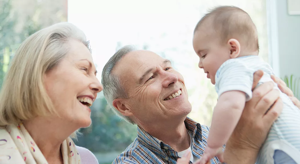 Grandparents holding an infant