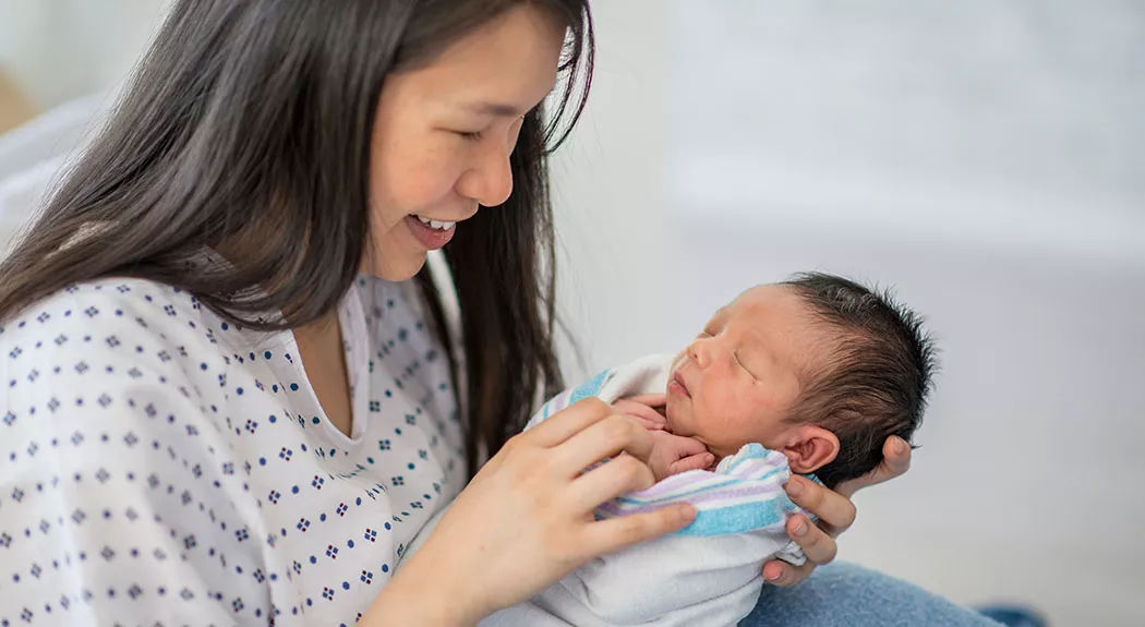 Woman holding a newborn baby