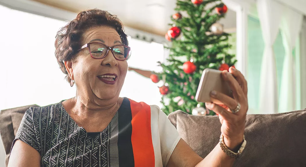 senior woman talking on a smartphone at Christmas