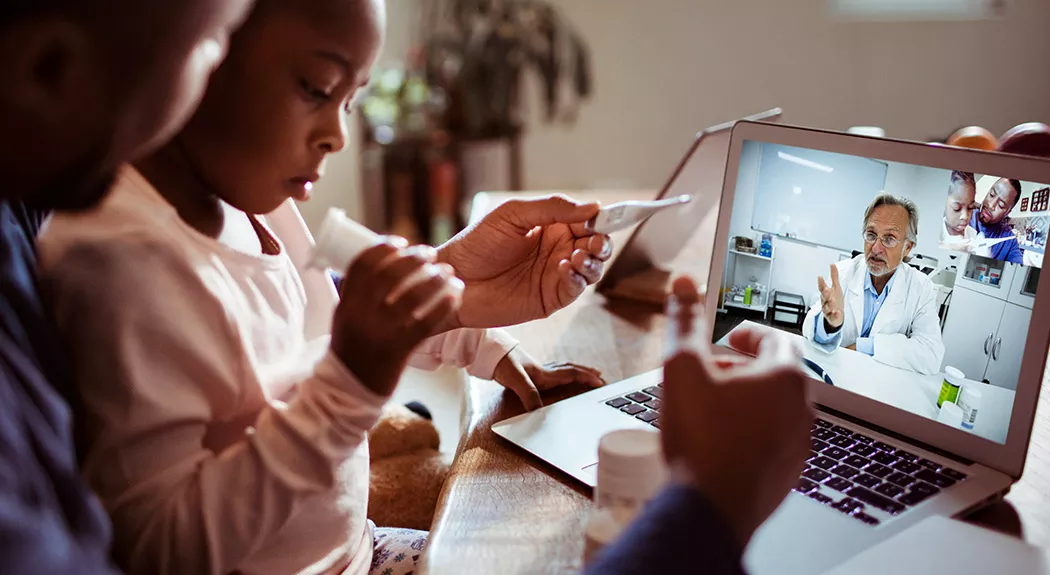 African-American family having telehealth visit with their doctor