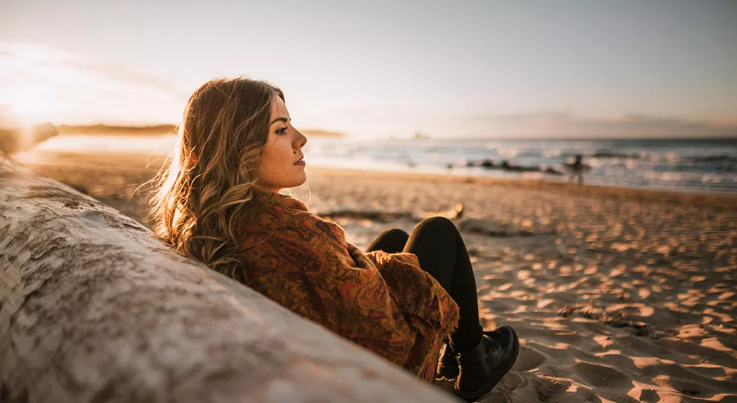 woman sitting on the beach